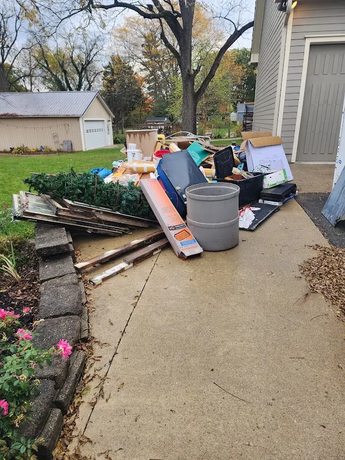 Dumpster being loaded with debris for 12 Yard Dumpster Rental in Coal Valley